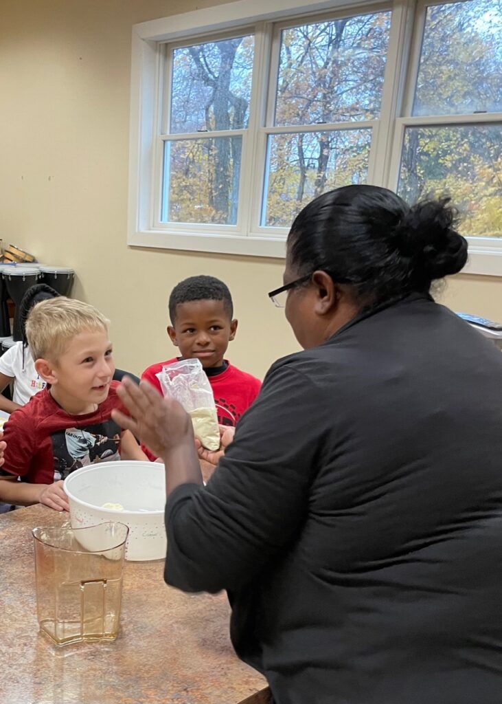  Students engaging in hands-on learning activities in Delphi Academy's modern classroom setting on National Pastry Day